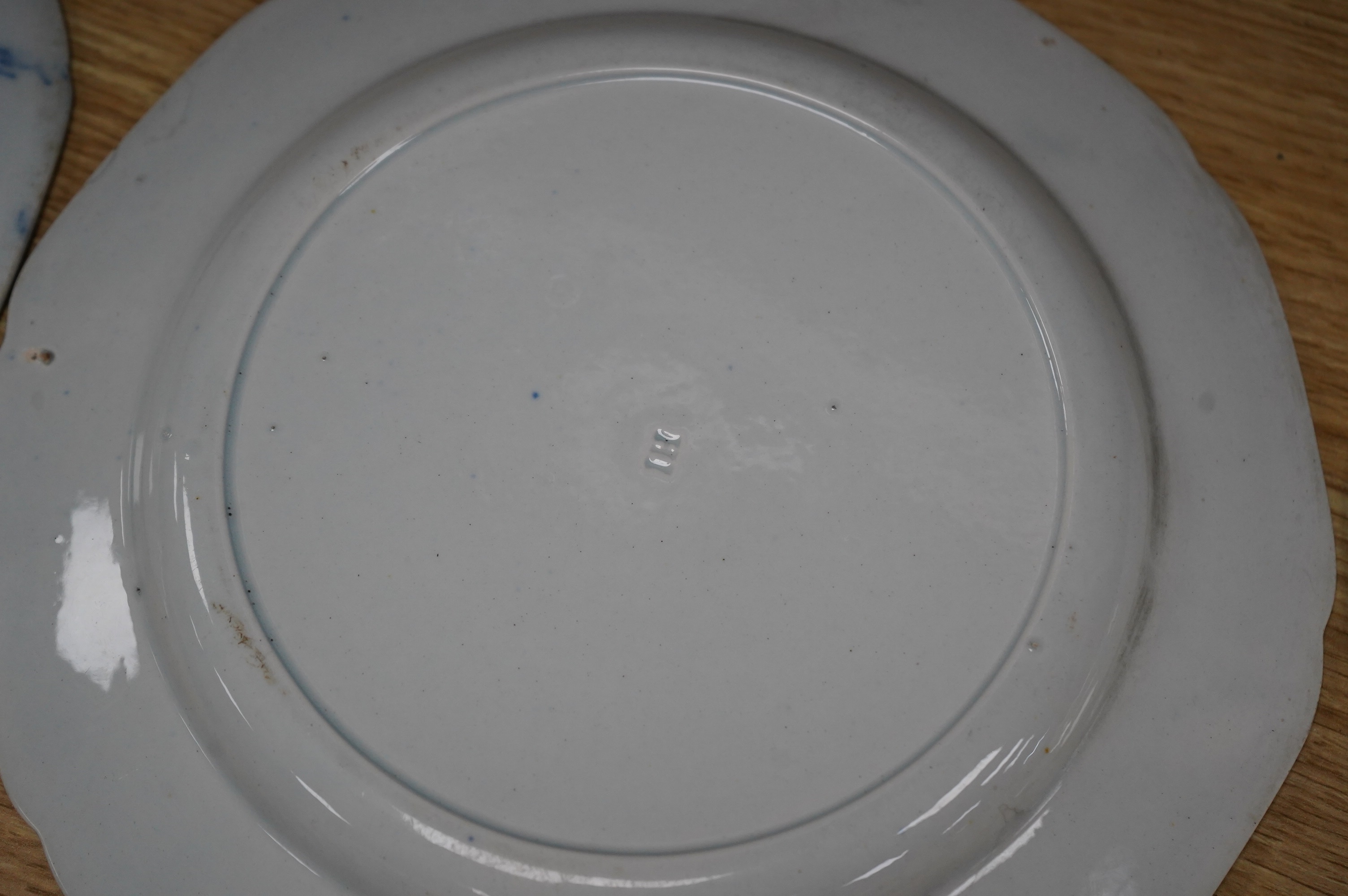 Four early 19th century English pearlware blue and white plates, largest 23.5cm. Condition - fair